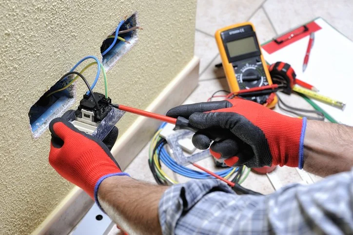 electrician installing outlet