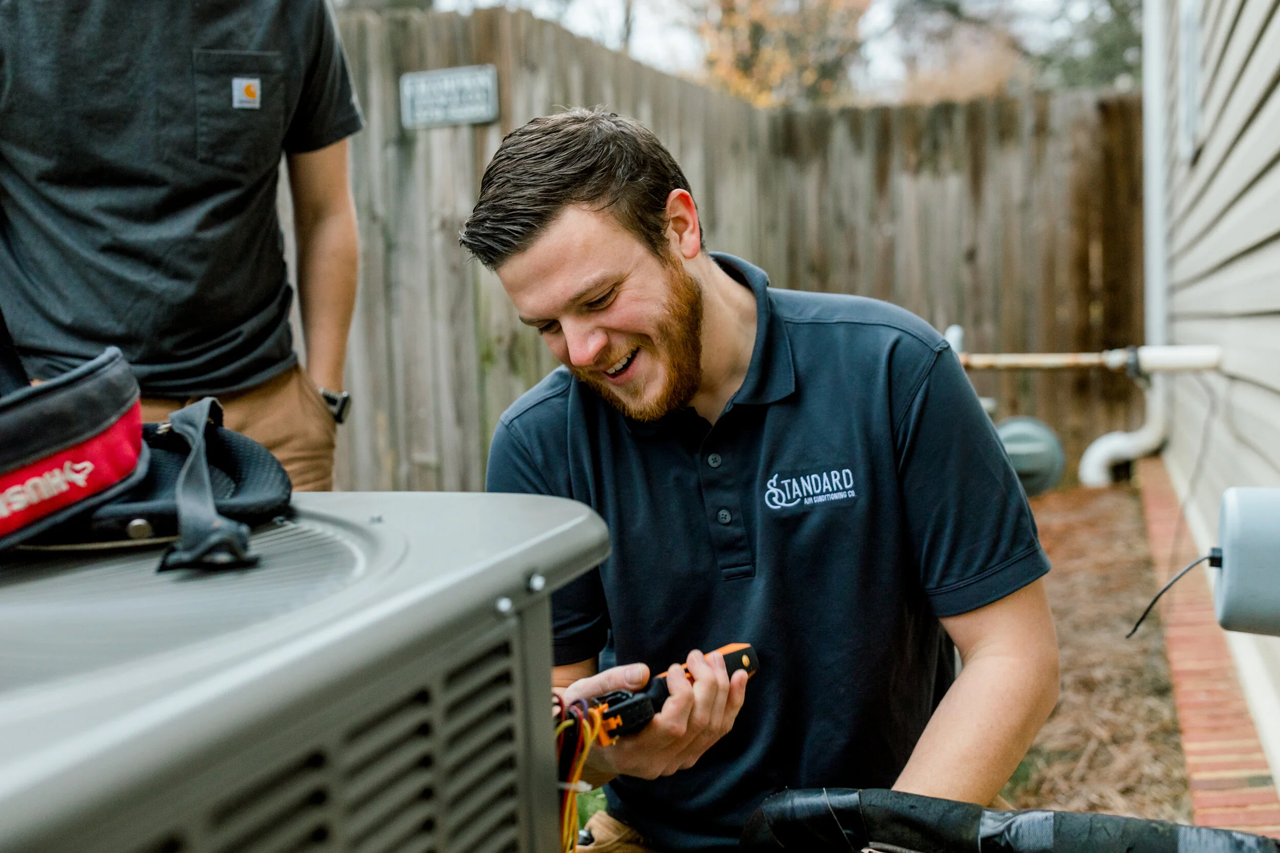 Tech repairing AC system
