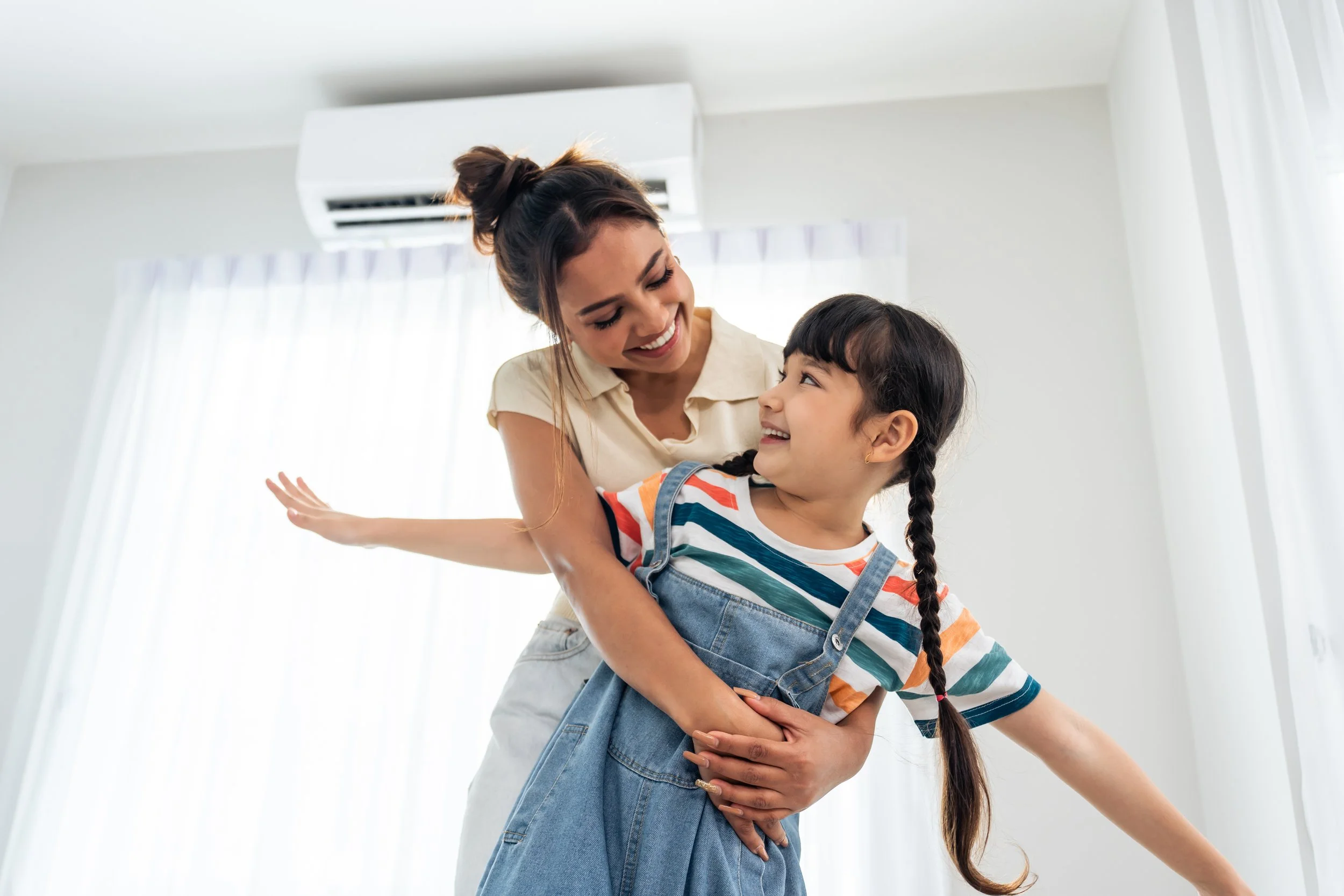family playing in home with ductless unit
