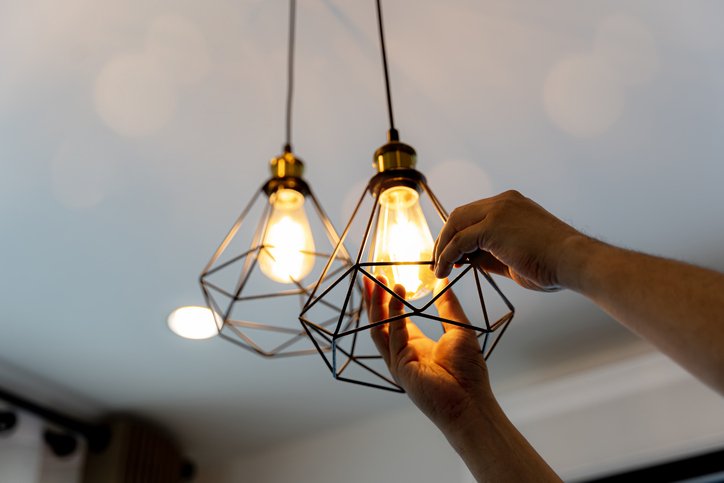 electrician installing lighting fixture