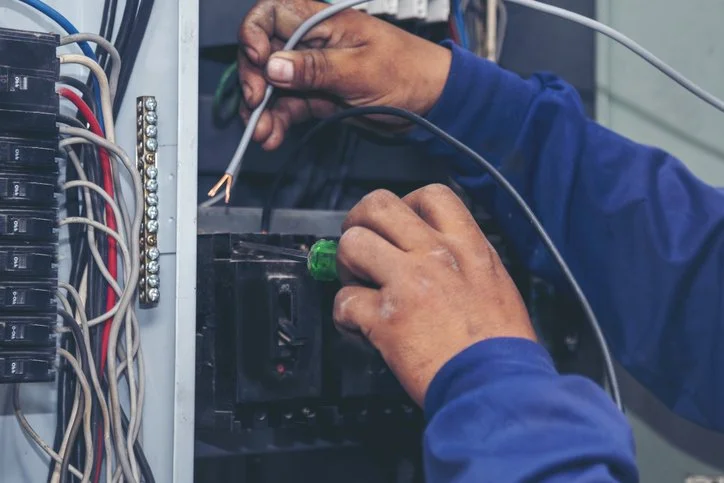 electrician wiring a panel