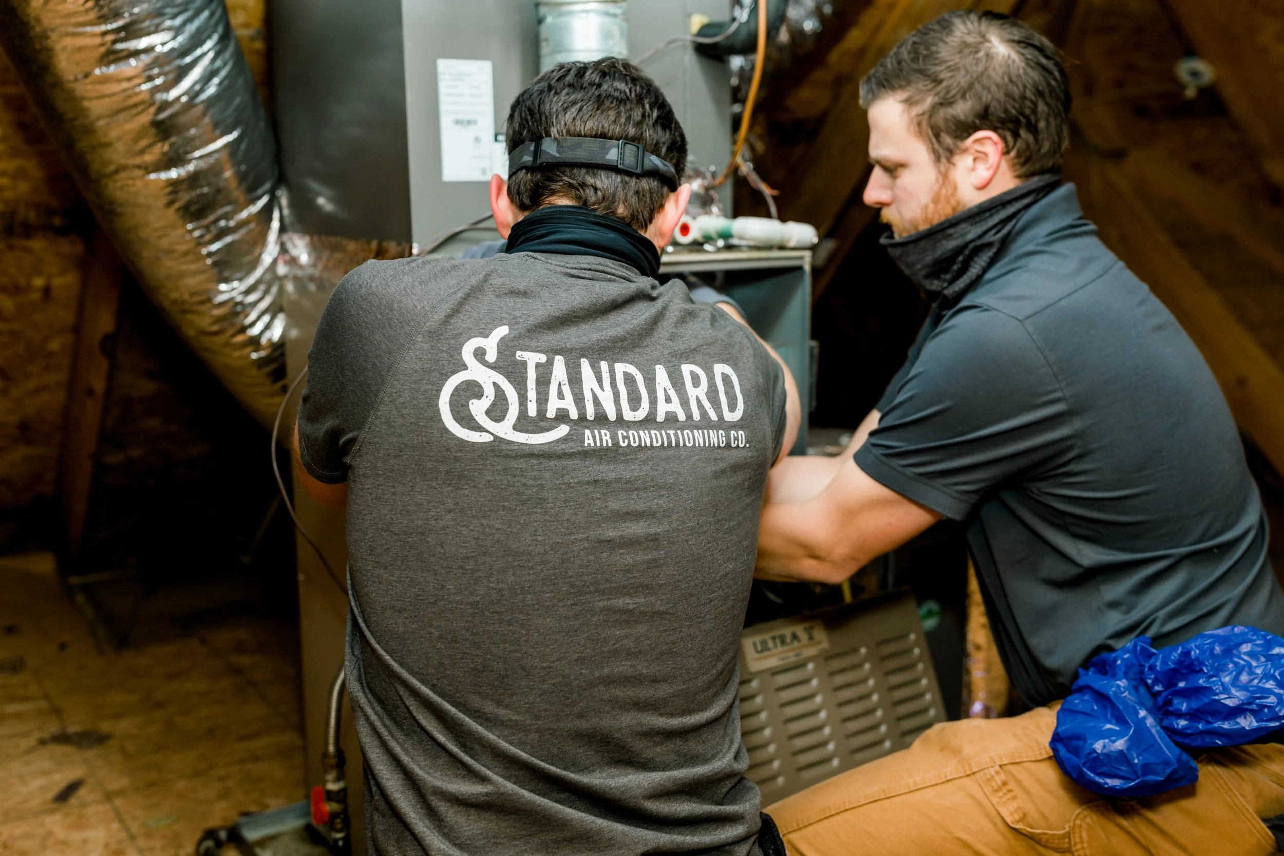 Technicians working on a furnace