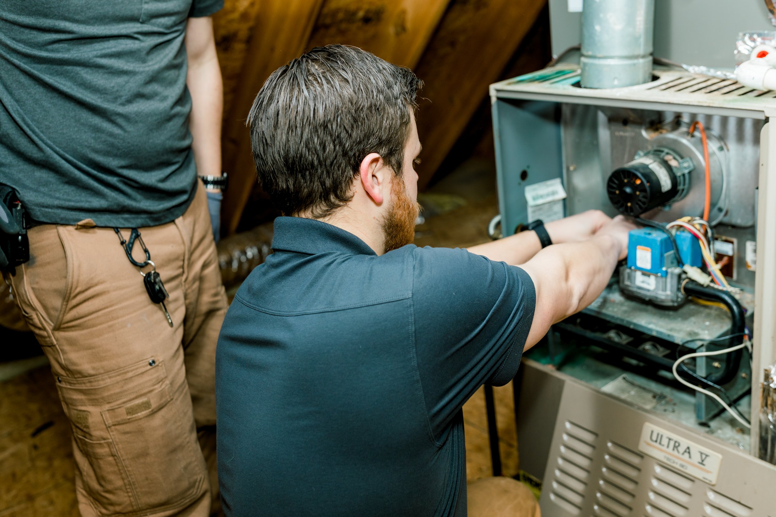 technician repairing a furnace